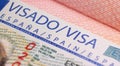 Yerevan, Armenia, December 25, 2023: Closeup Spain visa focusing on the word VISA. Schengen visa stamp background