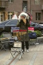 On the street of Yerevan musician in a headdress of feathers, playing a melody on the pan flute with Peruvian ethnic motifs