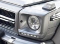 Yerevan, Armenia, February 25, 2023: Mercedes G-Class G-63. Close-up of the headlights detail. Side view matt gray Mercedes Benz G