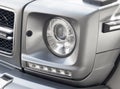 Yerevan, Armenia, February 25, 2023: Mercedes G-Class G-63. Close-up of the headlights detail. Side view matt gray Mercedes Benz G