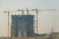A large building under construction with cranes in Royalty Free Stock Photo