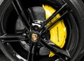 Yerevan, Armenia, March 15, 2023 : Front view of logo of Porsche Taycan on alloy wheel. Car exterior details. Tyre and alloy wheel Royalty Free Stock Photo