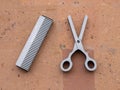 Yerevan, Armenia - 27 March 2023: Scissors and comb as hairdressing supplies on the facade of the hairdresser Royalty Free Stock Photo