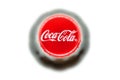 Yerevan, Armenia, May 10, 2023: Coca Cola logo on a cork cap. Black bottle of Coca-Cola sparkling water. Top view. Classic company