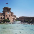 Yerevan - capital city of Armenia. Republic square, center, sunny summer day, clear blue sky, fountain and armenian flag Royalty Free Stock Photo