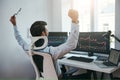 Yes Back view of stock trader with raised hands looking at multiple computer screens with data and charts and feeling Royalty Free Stock Photo