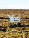 Yes in big white wooden letters with Scottish moorland in the background