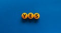 Yes choice symbol. Orange table tennis balls with the word `yes`. Beautiful blue background. Business, choice and yes concept, Royalty Free Stock Photo