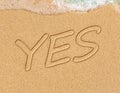 YES concept, positive changes in the life, word written on sand beach Royalty Free Stock Photo