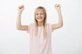 Yes, cute little champion happy to win in computer game. Studio portrait of positive cheerful adorable girl with fair Royalty Free Stock Photo