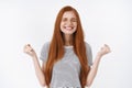 Yes finally success. Charming gentle devoted redhead cute girl close eyes smiling delighted clench fists victory triumph