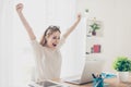 Yes! Happy excited woman at home workstation triumphing with rai Royalty Free Stock Photo