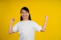 Yes. Happy little asian girl shaking fists, making winner gesture Royalty Free Stock Photo