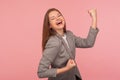 Yes I did it! Portrait of successful enthusiastic young woman in business suit screaming for joy with raised fists Royalty Free Stock Photo