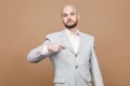 Yes I am. serious proud handsome middle aged bald bearded businessman in classic light gray suit standing looking Royalty Free Stock Photo