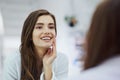 Yes its true, Im perfect. an attractive young woman looking into a mirror with her hand touching her cheek at home Royalty Free Stock Photo