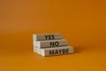 Yes No Maybe symbol. Concept word Yes No Maybe on wooden blocks. Beautiful orange background. Business and Yes No Maybe concept. Royalty Free Stock Photo