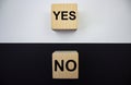 Yes and no, text on wooden cubes on a white and black background. The concept of choice. Positive and negative Royalty Free Stock Photo