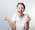 Yes. Pretty extremely happy woman celebrating her success with raised hands. Girl isolated on white background Royalty Free Stock Photo