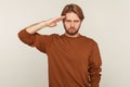 Yes sir! Portrait of patriotic guy with beard in sweatshirt saluting and listening to command, ready to obey