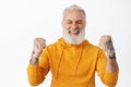 Yes success. Smiling happy senior man triumphing, celebrating win and victory, make fist pump with rejoice, looking Royalty Free Stock Photo