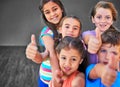 Yes you can. Studio shot of a diverse group of kids showing thumbs up against a gray background. Royalty Free Stock Photo