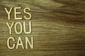 Yes You Can text message on wooden background Royalty Free Stock Photo