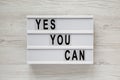 `Yes you can` words on a lightbox over white wooden background, top view. Overhead, from above. Flat lay. Close-up Royalty Free Stock Photo