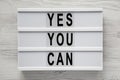 `Yes you can` words on a modern board over white wooden background, top view. Overhead, from above. Flat lay Royalty Free Stock Photo