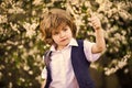Yes you. carefree boy show thumb up. small boy at blossoming spring tree. happy kid has lush healthy hair. summer and