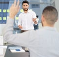 Yes, you have something to say. Shot of a young businessman leading a discussion during a meeting in a boardroom. Royalty Free Stock Photo