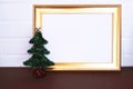 Christmas tree and golden wood frame on white background