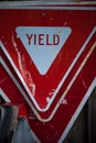 Yield road signs staked on top of each other