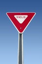 Yield sign on blue sky