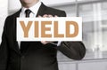 Yield sign held by businessman concept