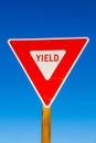 yield Sign at the highway with blue sky Royalty Free Stock Photo