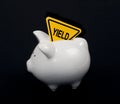 Yield sign in piggy bank