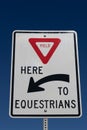 Yield to Equestrians sign against dark blue sky Royalty Free Stock Photo