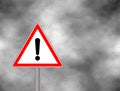 Yield Triangle Sign - Road traffic coordination symbol on clouds background. Road sign warning attention with an exclamation mark.