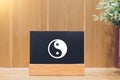 Yin and yang on a blackboard and wooden background