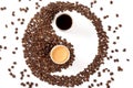 Yin yang symbol made from roasted coffee beans, espresso and coffee with milk in paper cups Royalty Free Stock Photo