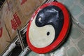 A yin and yang symbol on a signboard above a shop entrance, Dongguan, Guangdong Province, China