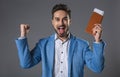 Happy smiling man holding tickets in hand Royalty Free Stock Photo