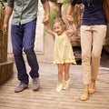 Yippee Were going on an adventure. A little girl holding her parents hands while on an outing. Royalty Free Stock Photo