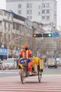 Female street sweeper on a tricycle in urban environment, Yiwu, China