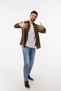 Yo man. Full-length vertical studio shot cool and stylish handsome confident and sassy young bearded man, gesturing with