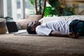 Yoga. African young man meditating on a floor and lying in Shavasana pose. Royalty Free Stock Photo