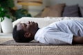 Yoga. African young man meditating on a floor and lying in Shavasana pose. Royalty Free Stock Photo