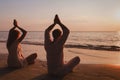 yoga on the beach, couple silhouettes in lotus position Royalty Free Stock Photo