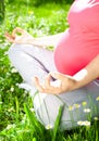 Yoga, Beautiful pregnant woman relaxing in the park.